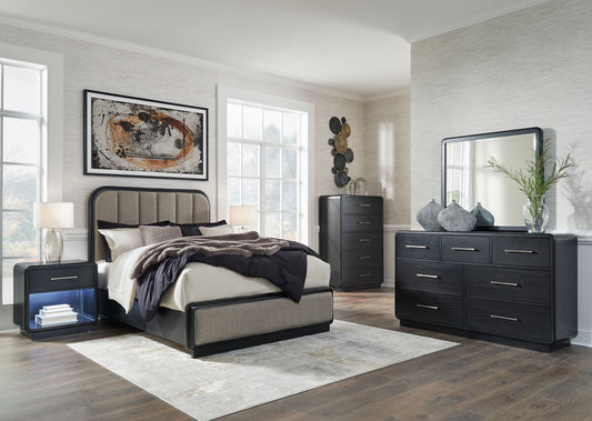 Modern bedroom set with bed, nightstands, dresser, and mirror in a well-lit room.