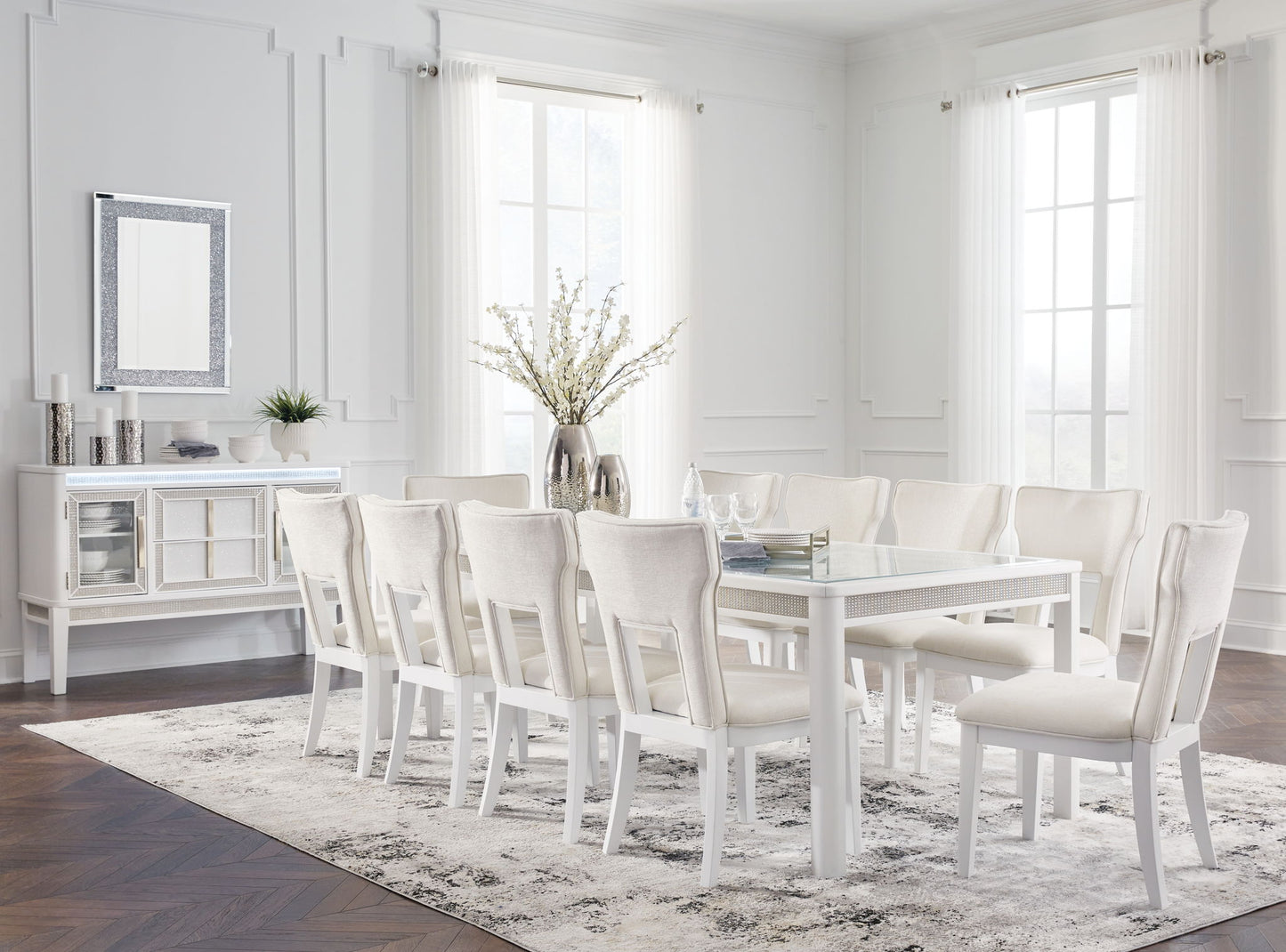 White dining room with a table and chairs in a bright room.
